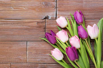 Bouquet of tulips on a brown wooden table