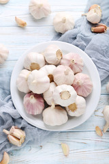 Garlic in plate on blue wooden table