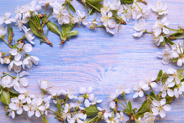 Frame of Spring Flowers on the background of old vintage blue board