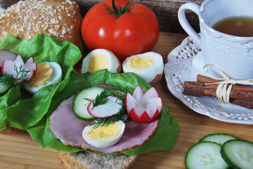 Radish flowers on sandwiches with egg and ham