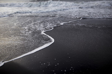 Fototapeta premium Black sand beach on the sunrise with white Indian ocean. Nobody in the beach. Paradise