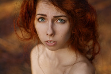 A large portrait of a red-haired girl