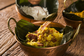 Rice with coconut, Yellow flour and  dried meat with rice in an old copper pot - Traditional bahia food
