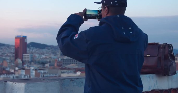black african american treveler makes a city panorama photos on smartphone