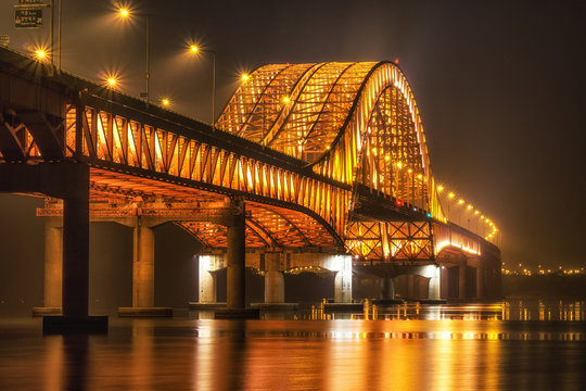 banghwa bridge at night over the han river in seoul, south korea