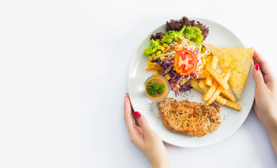 Grilled steaks, baked potatoes and vegetables on white plate on white background.
