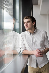 Fototapeta premium young businessman in startup office by the window