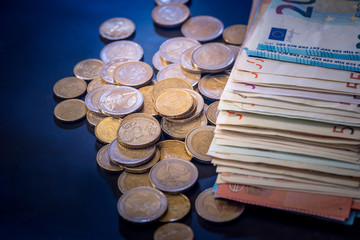 euro coin and banknote isolated on black background