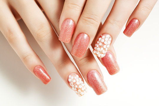 Fototapeta Pink nails. Female manicure and floral patterns.
