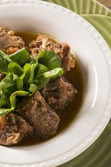 Brazilian traditional food called oxtail with arugula