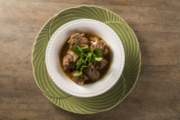 Brazilian traditional food called oxtail with arugula
