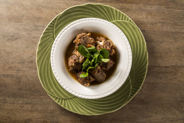 Brazilian traditional food called oxtail with arugula