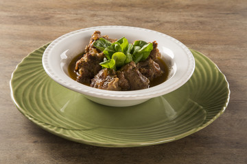 Brazilian traditional food called oxtail with arugula