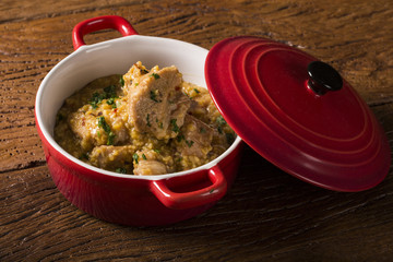 Brazilian dish canjiquinha or pela egua in red bowl.