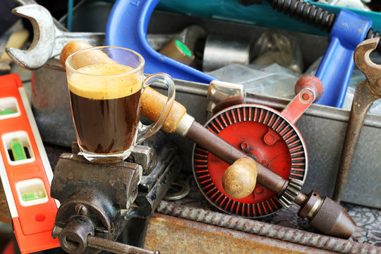 Cup of coffee on Locksmith's vise.