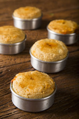 Empada Brazilian snack. pie with shrimp on wooden background