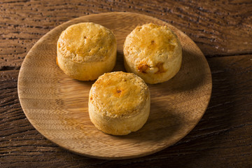Empada Brazilian snack. pie with shrimp on wood plate on wooden background