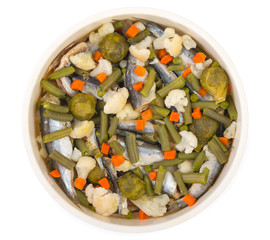 Diet foods. Sea fish with vegetables, steamed. There are pieces of carrots, green peas, asparagus beans, colored and Brussels sprouts. Tor view, close up.