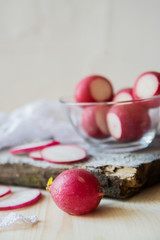 glass with radish and half of radish on the wooden background.top view