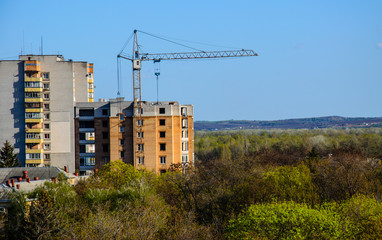 Obraz premium High construction crane against blue sky
