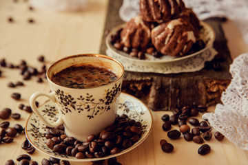 Vanilla muffins with fresh coffee for breakfast on a black background