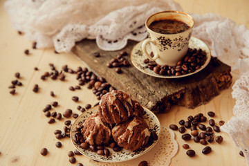 Vanilla muffins with fresh coffee for breakfast on a black background
