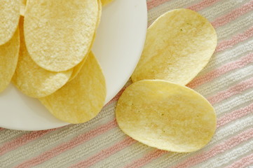 crispy and salt potato chips on plate