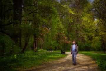 The boy walks in garden