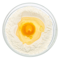 Flour with egg in glass bowl