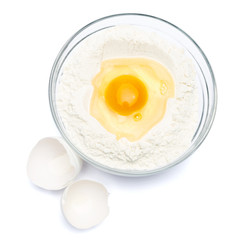 Flour with egg in glass bowl