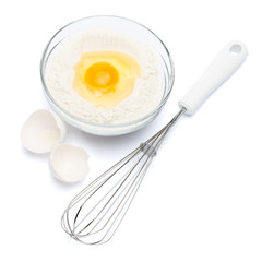 Flour with egg in glass bowl