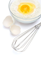 Flour with egg in glass bowl