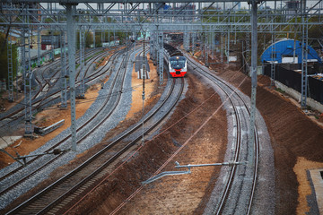 Fototapeta na wymiar The railway track, the approaching train on the railroad
