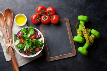 Healthy salad and fitness equipment