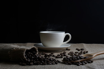 Coffee cup and coffee beans on Burlap Texture