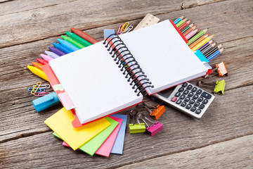 Notepad for your text over colorful supplies