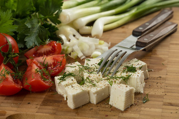 organic cheese and tomatoes on wooden cutting board