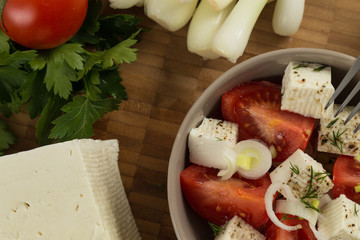 organic cheese and tomatoes on wooden table top view