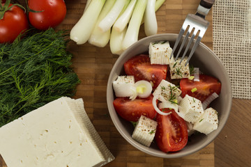 organic cheese and tomatoes on wooden table top view