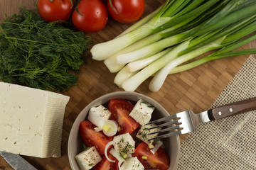 organic cheese and tomatoes on wooden table top view
