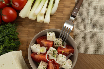 organic cheese and tomatoes on wooden table top view