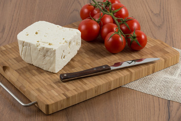 organic cheese and tomatoes on wooden table