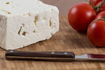 organic cheese and tomatoes on wooden table