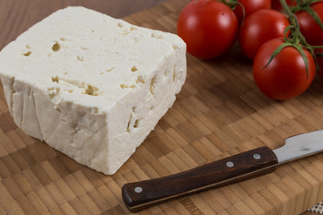 organic cheese and tomatoes on wooden table