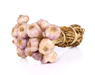 Garlic bulbs tied together white background