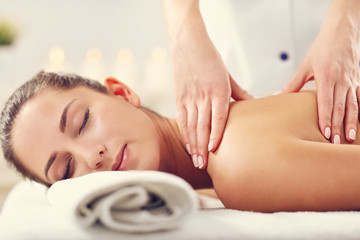 Obraz na płótnie Canvas Beautiful woman getting massage in spa