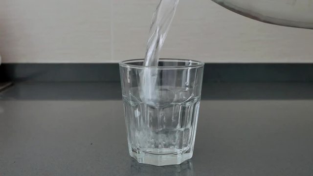 Pouring water to a glass slow motion