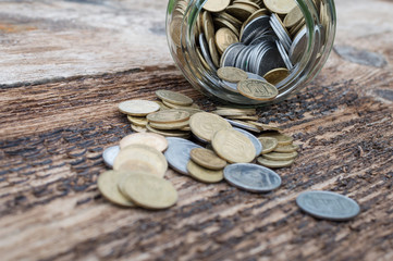 Ukrainian coins in glass jar on a wooden background