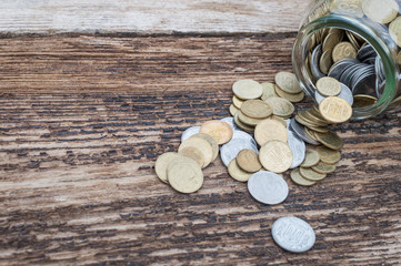 Ukrainian coins in a jar on a wooden background