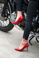 Fototapeta na wymiar Feet girl on a motorcycle